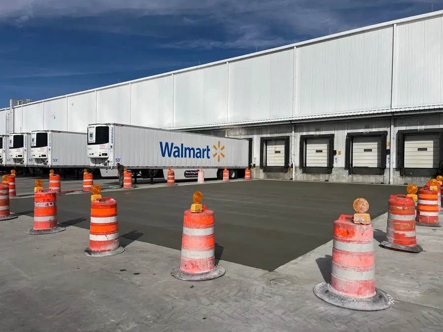 Traffic barrels around new concrete at the Walmart loading docks