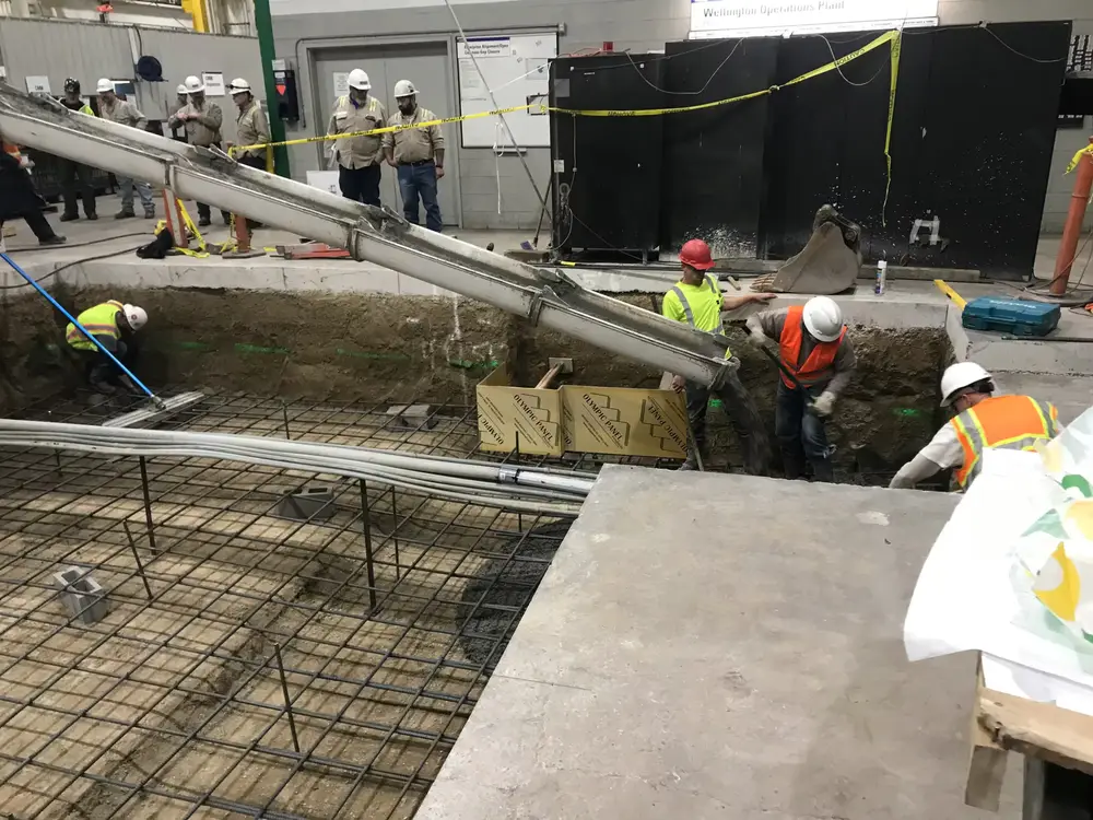 B Hansen Construction crew placing concrete over rebar on a foundation pour